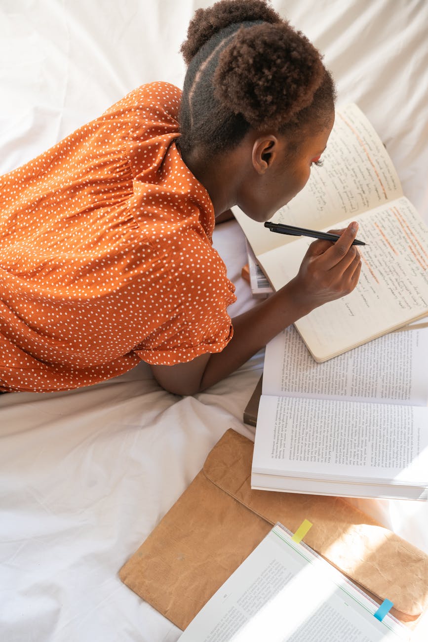photo of woman writing on notebook