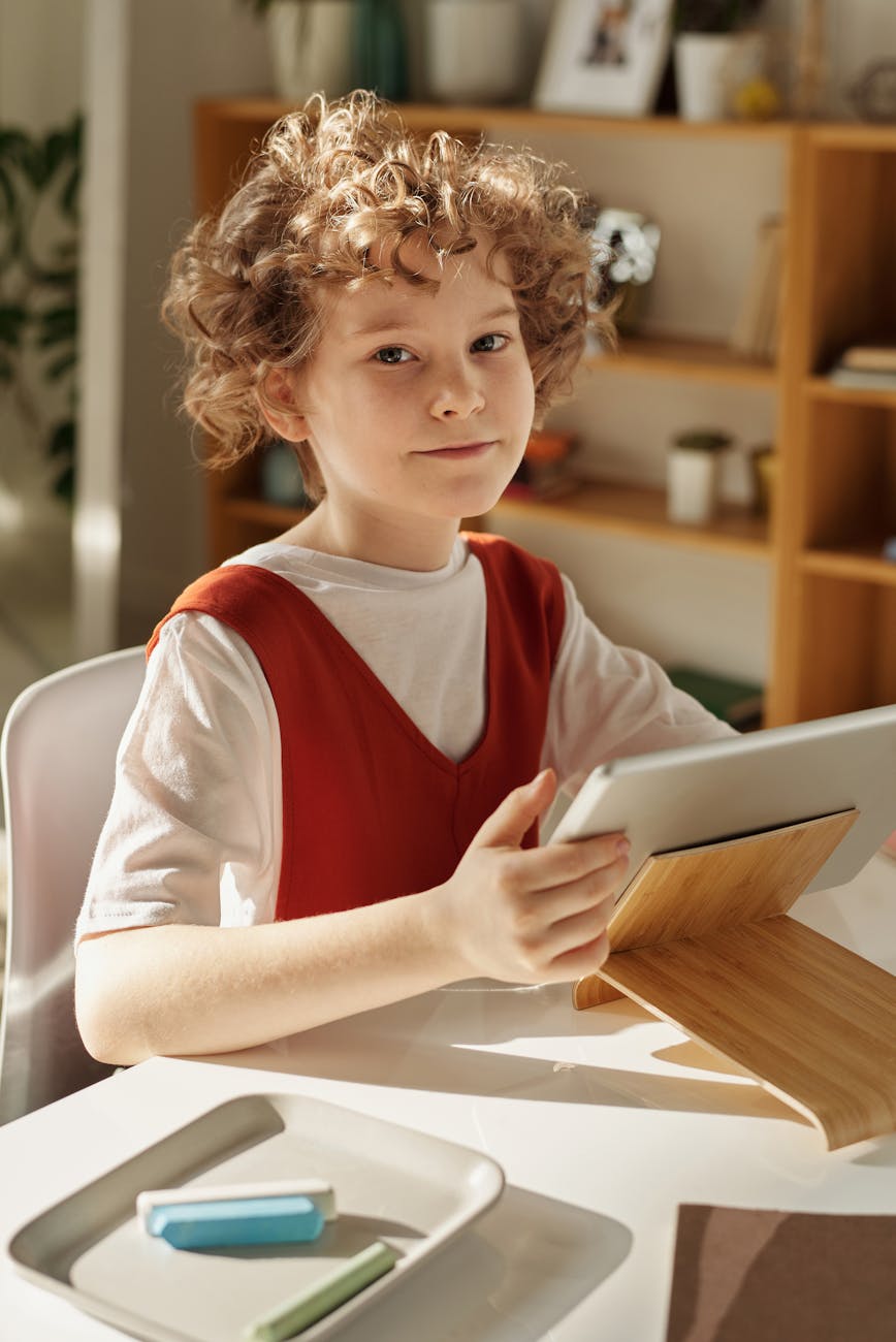 girl in white and red crew neck t shirt using tablet